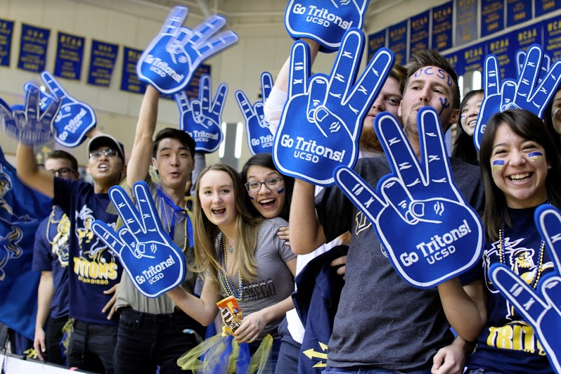 Students with foam fingers cheer at Spirit Night.