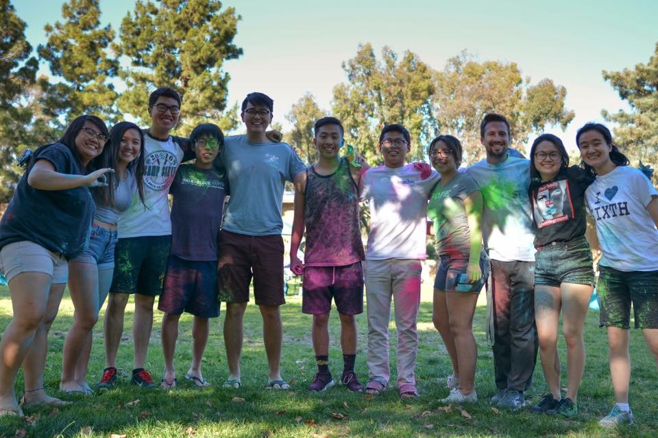 Students posing covered in colored powder